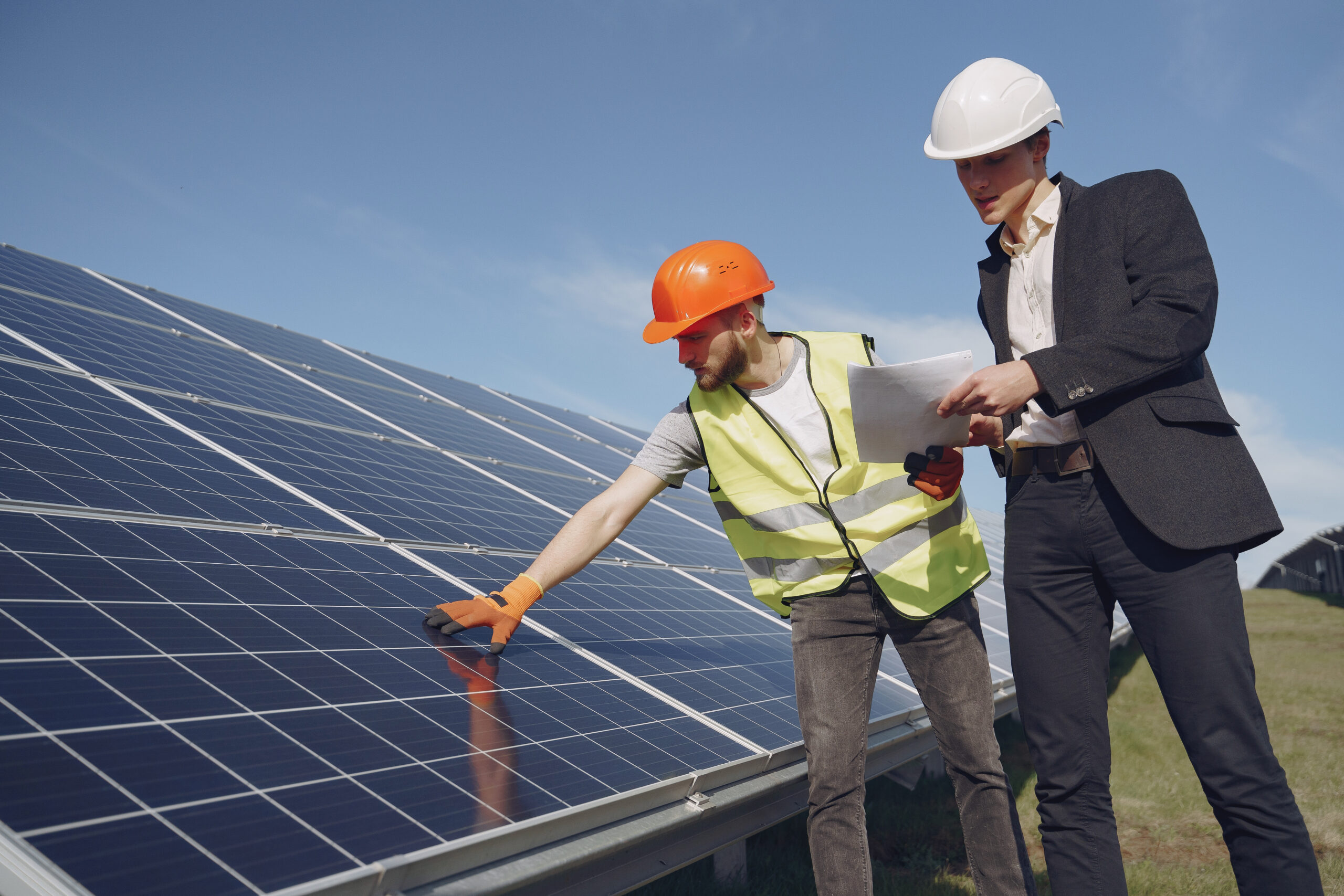 Foreman and businessman at solar energy station